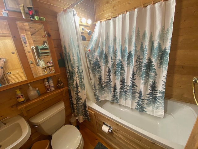 full bathroom with shower / bath combination with curtain, wooden walls, sink, and toilet