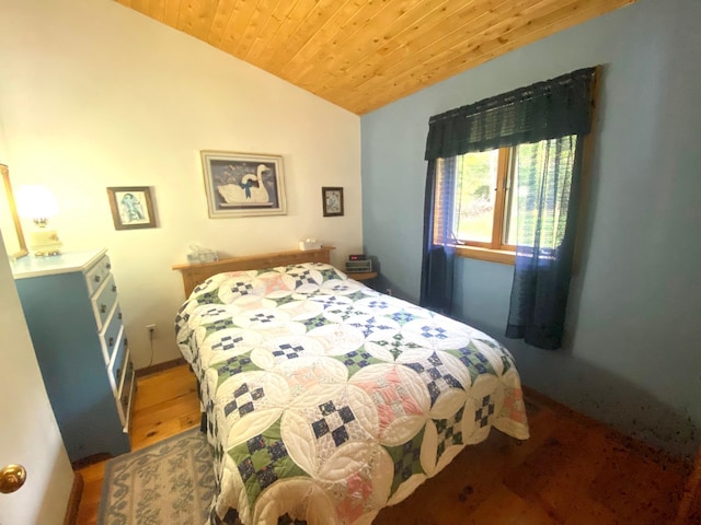 bedroom with lofted ceiling, dark hardwood / wood-style flooring, and wooden ceiling