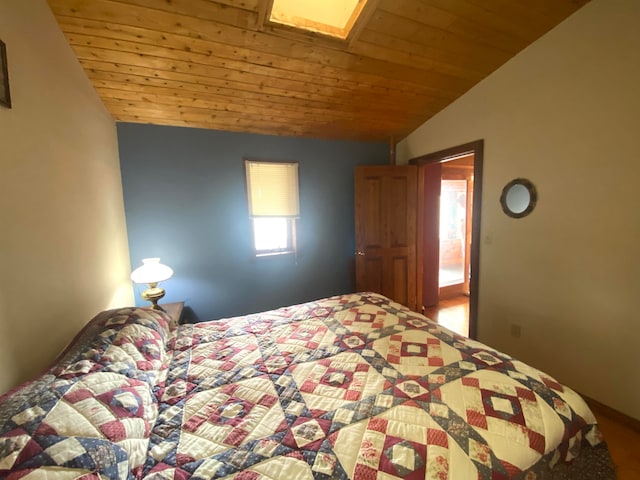 unfurnished bedroom with wooden ceiling and vaulted ceiling with skylight