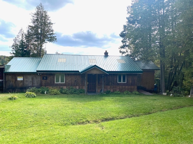 back of property featuring a lawn