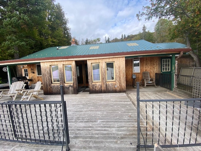 back of house with a wooden deck