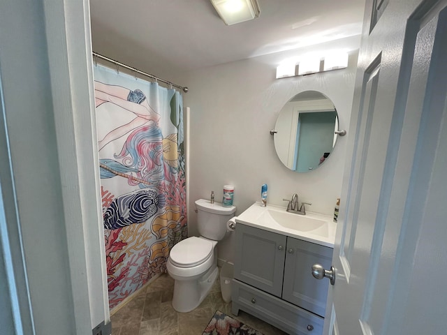 bathroom featuring walk in shower, vanity, and toilet