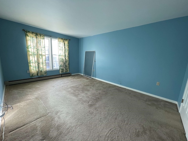 carpeted spare room featuring baseboard heating