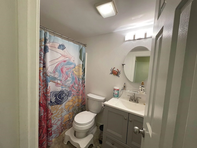 bathroom featuring tile patterned floors, vanity, toilet, and walk in shower