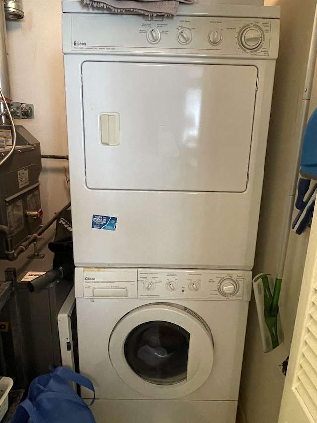 laundry area with stacked washer and dryer