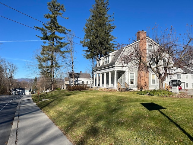 view of side of property with a yard