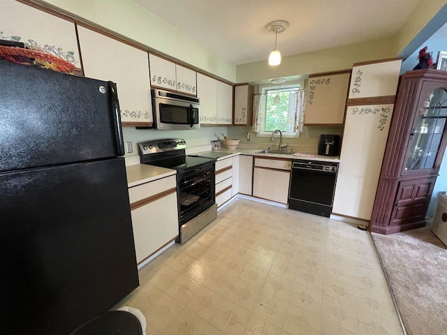 kitchen with white cabinetry, hanging light fixtures, black appliances, and sink