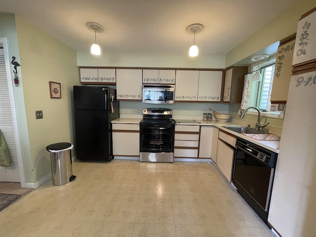 kitchen with black appliances, sink, and hanging light fixtures