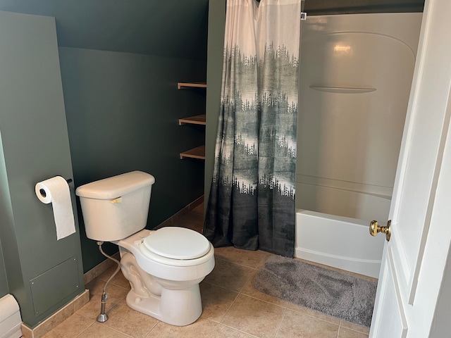 bathroom featuring shower / bathtub combination with curtain, tile patterned flooring, and toilet