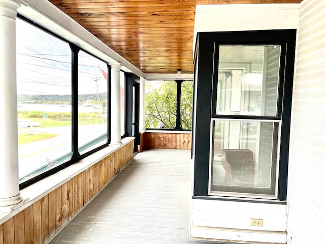 unfurnished sunroom with wood ceiling