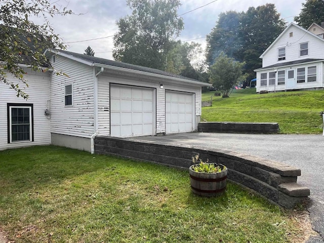 garage featuring a lawn