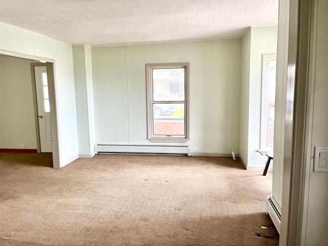 unfurnished room with light carpet and a baseboard heating unit