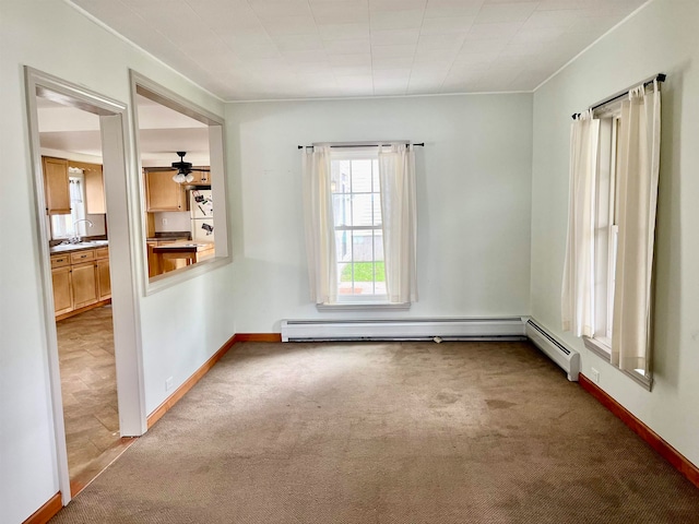 carpeted spare room with sink and ceiling fan