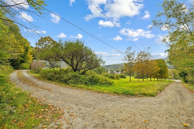 view of street with a rural view and a mountain view