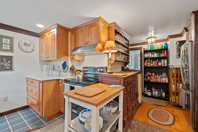 kitchen featuring ornamental molding, exhaust hood, wood counters, and stainless steel fridge