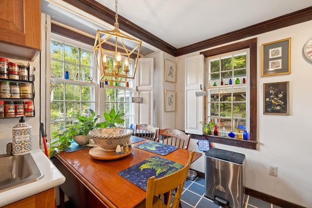 dining area featuring an inviting chandelier, ornamental molding, and sink