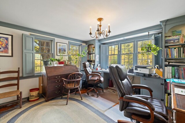 carpeted home office featuring a chandelier and crown molding