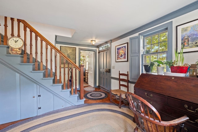 foyer with hardwood / wood-style flooring and crown molding