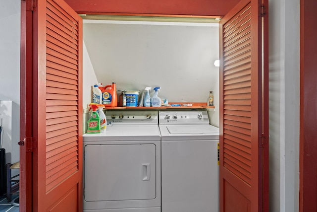 clothes washing area with washing machine and dryer