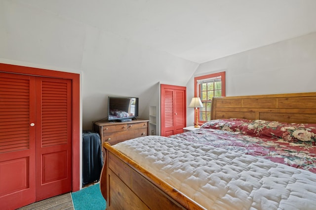 bedroom with lofted ceiling and carpet flooring