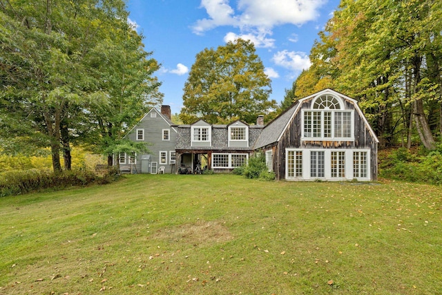 rear view of house with a yard