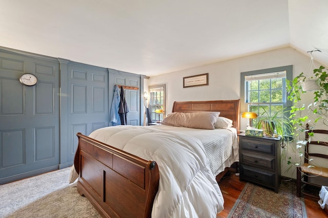 bedroom featuring vaulted ceiling, dark hardwood / wood-style floors, and a closet