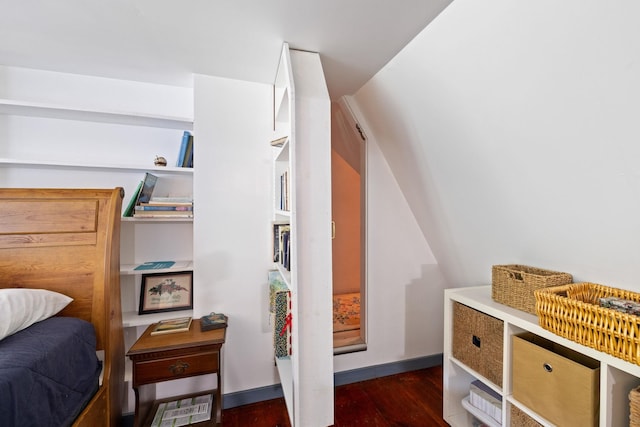 bedroom featuring lofted ceiling and dark hardwood / wood-style flooring