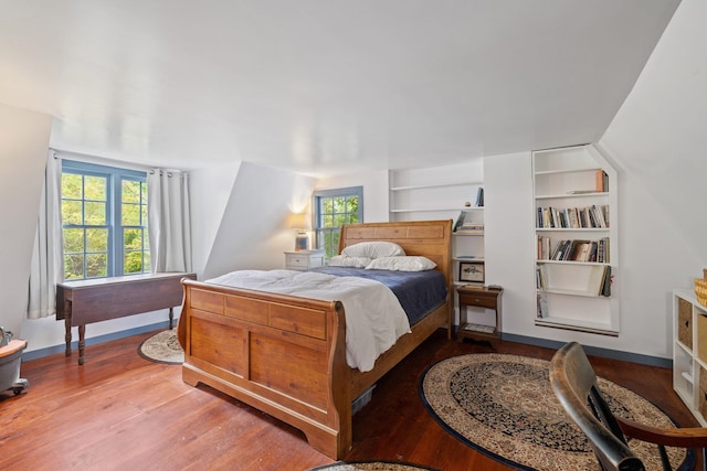 bedroom featuring multiple windows and hardwood / wood-style floors