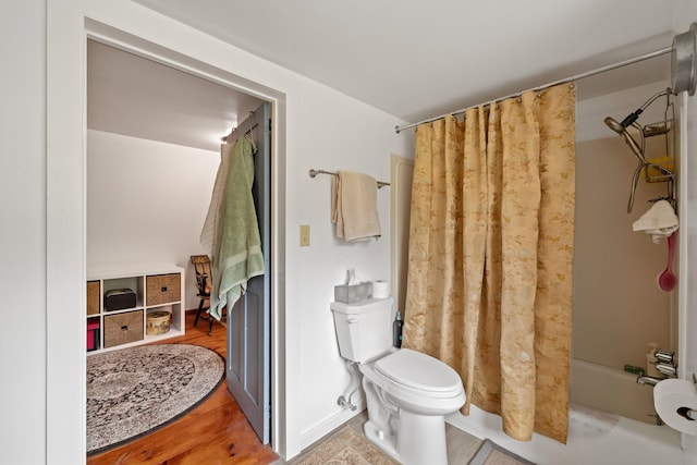 bathroom featuring wood-type flooring, toilet, and shower / tub combo with curtain