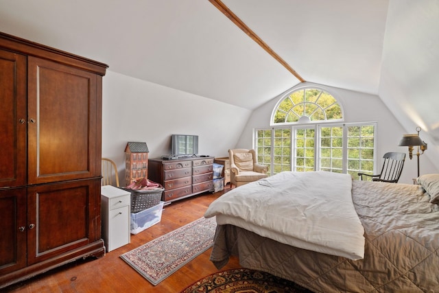 bedroom featuring vaulted ceiling and hardwood / wood-style flooring