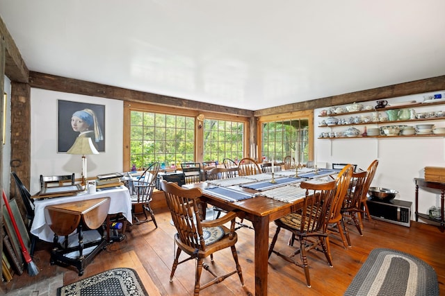 dining space with wood-type flooring