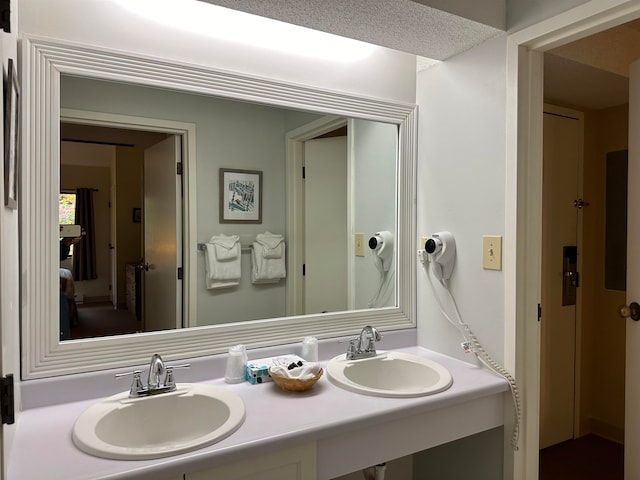 bathroom featuring a textured ceiling and vanity