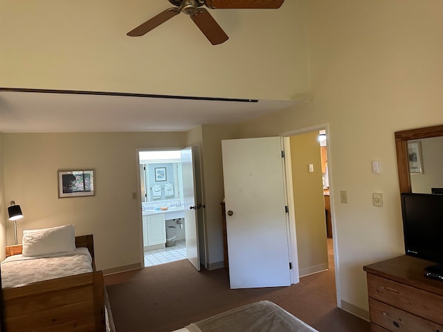 bedroom with ceiling fan, carpet flooring, and ensuite bathroom