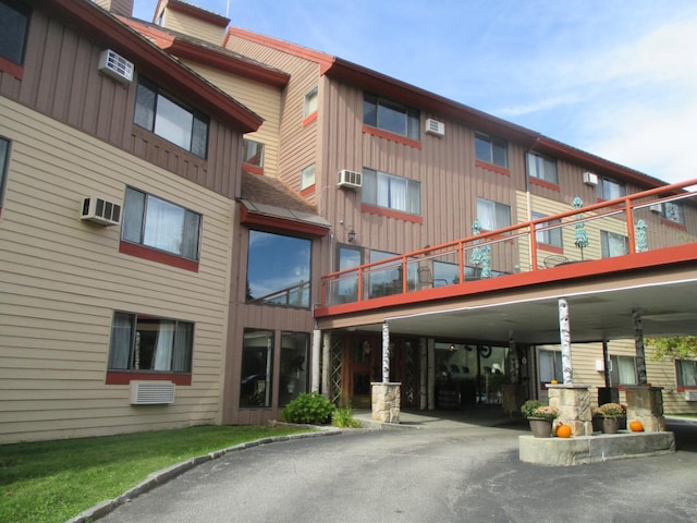 view of building exterior featuring a wall mounted AC