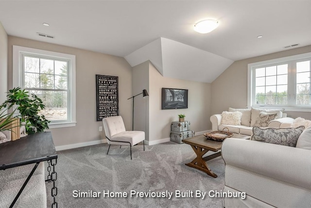 living room with light carpet, plenty of natural light, and vaulted ceiling