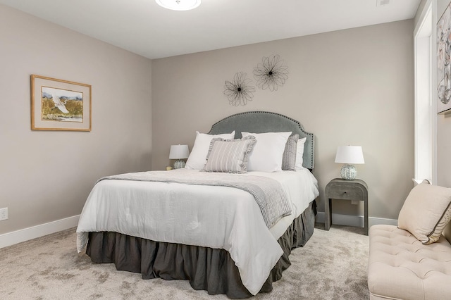 carpeted bedroom featuring baseboards