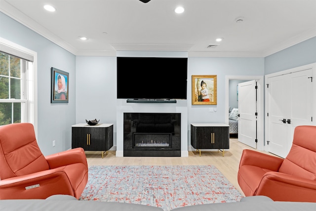 living room featuring light hardwood / wood-style floors and ornamental molding