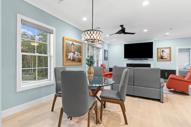 dining area with crown molding, ceiling fan, and light hardwood / wood-style flooring