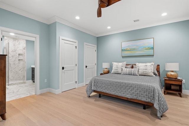 bedroom featuring light wood-type flooring, ceiling fan, and ensuite bathroom