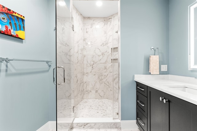 bathroom with vanity and a shower with shower door