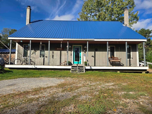 farmhouse inspired home featuring a porch and a front lawn