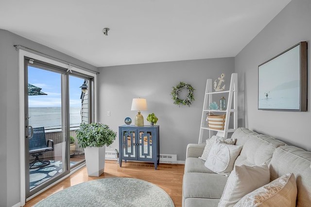 living room featuring a water view and hardwood / wood-style flooring