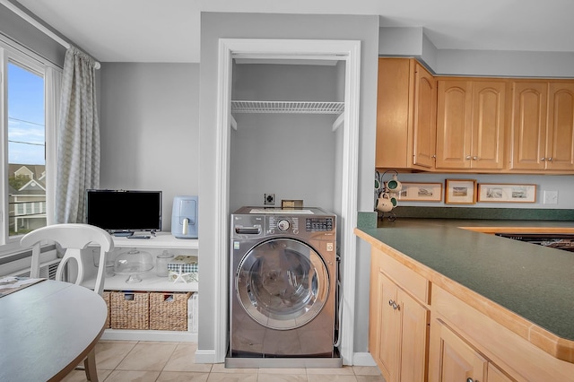 laundry room with light tile patterned floors, washer / dryer, and plenty of natural light