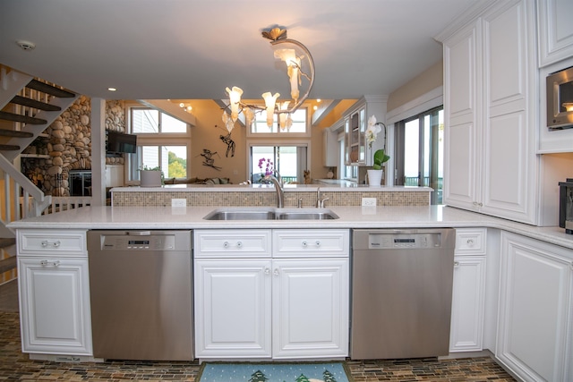 226 Okemo Trailside Ext Unit 47C, Ludlow, VT 05149 - kitchen with a sink, a notable chandelier, white cabinetry, light countertops, and appliances with stainless steel finishes