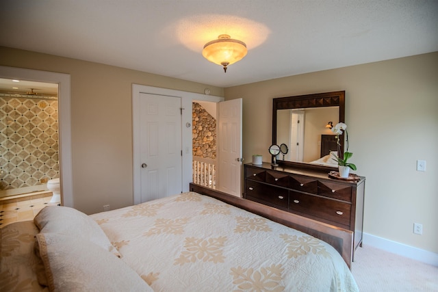 226 Okemo Trailside Ext Unit 47C, Ludlow, VT 05149 - carpeted bedroom with connected bathroom and baseboards