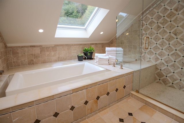226 Okemo Trailside Ext Unit 47C, Ludlow, VT 05149 - bathroom with tile patterned floors, lofted ceiling with skylight, a garden tub, and a stall shower