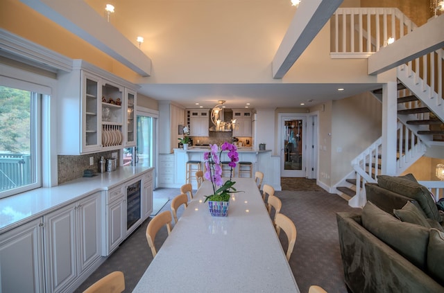 226 Okemo Trailside Ext Unit 47C, Ludlow, VT 05149 - dining space featuring dark carpet, stairs, and plenty of natural light