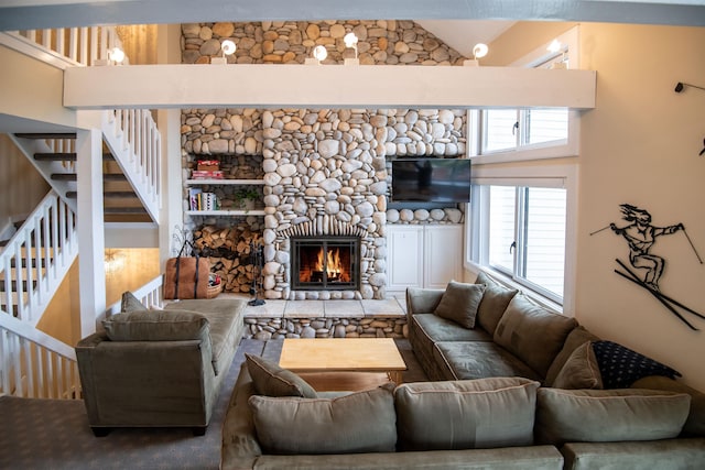 226 Okemo Trailside Ext Unit 47C, Ludlow, VT 05149 - living area with a stone fireplace, stairway, and plenty of natural light