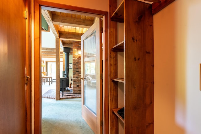 hallway with wood ceiling, beam ceiling, and carpet floors