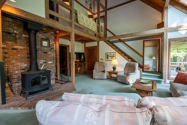 carpeted living room featuring beam ceiling, a wood stove, and high vaulted ceiling